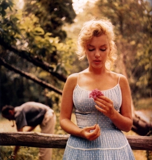 Marilyn Monroe on her honeymoon Arthur Miller in background